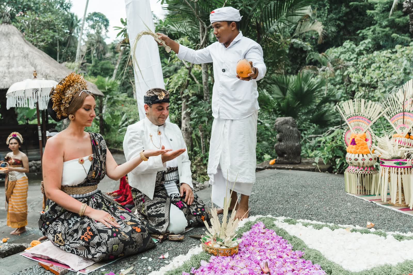 Couple receiving a sacred Balinese purification blessing