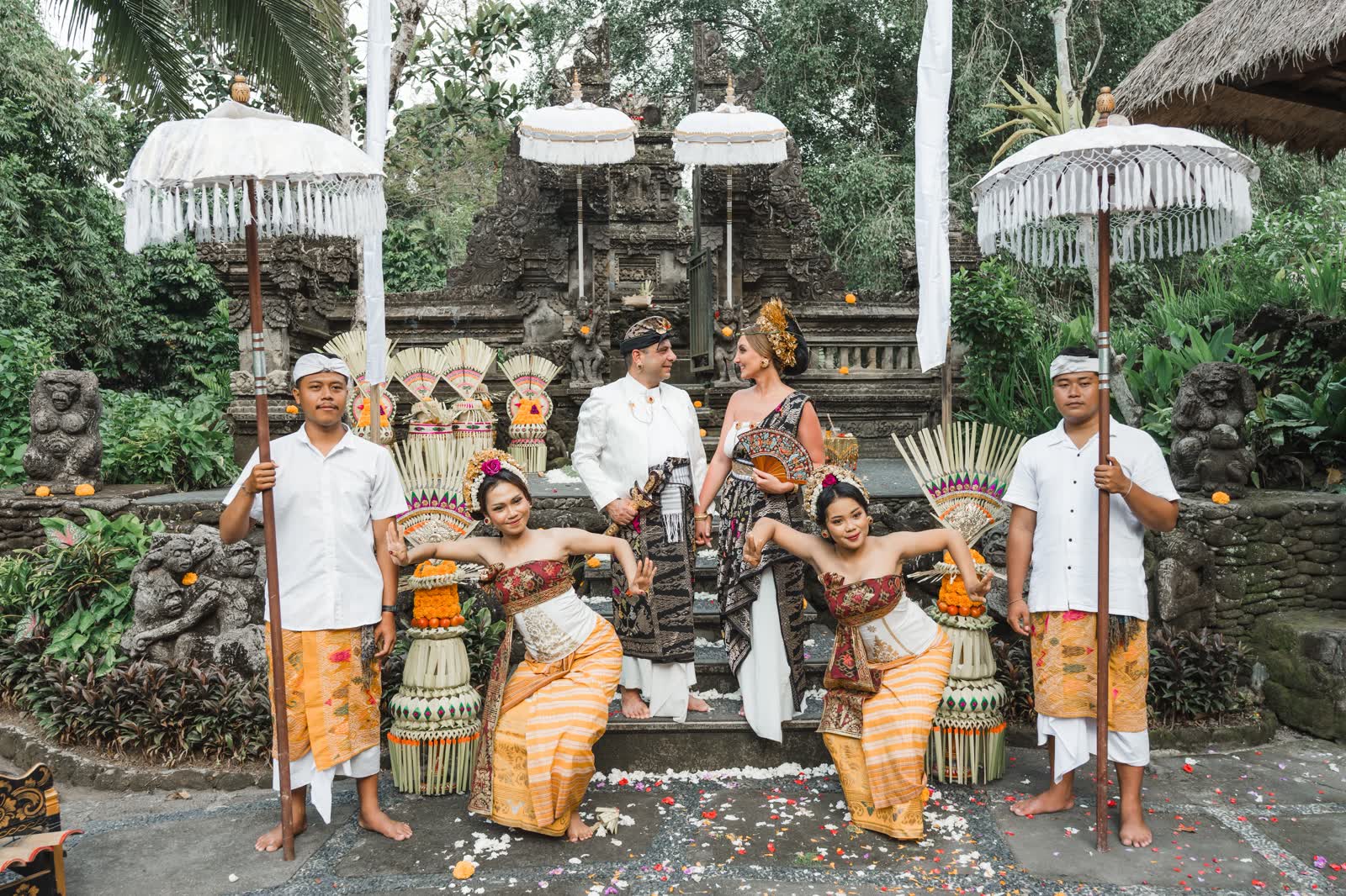 Couple with their Balinese blessing ceremony attendants at a traditional temple